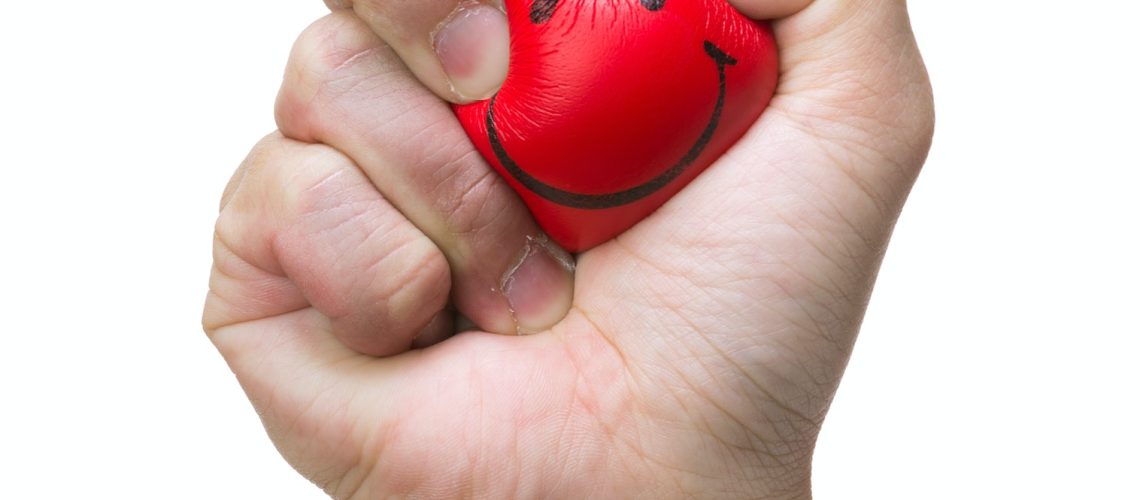 Hand squeezing smile face stress ball