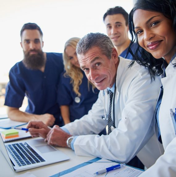 The medics looking at camera at laptop